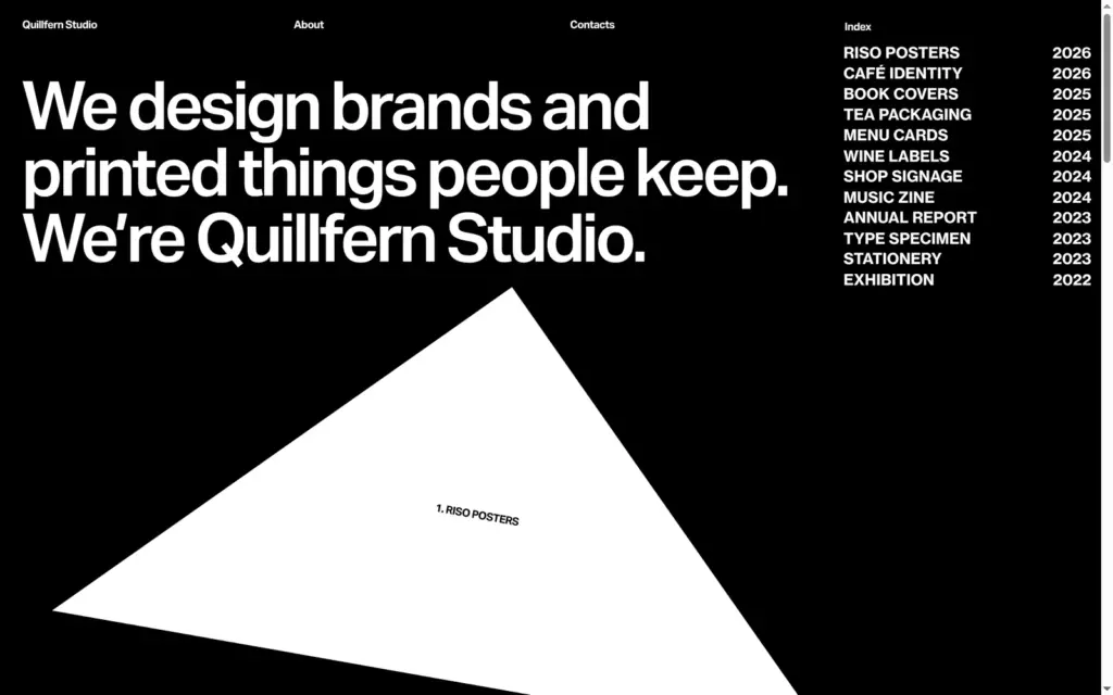 Quillfern Studio home page on a computer, with a black background, a large headline and a white paper shape